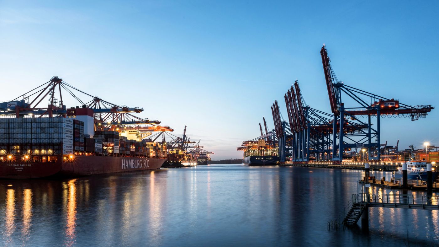 Illuminated cargo ships and cranes at Hamburg port, Germany