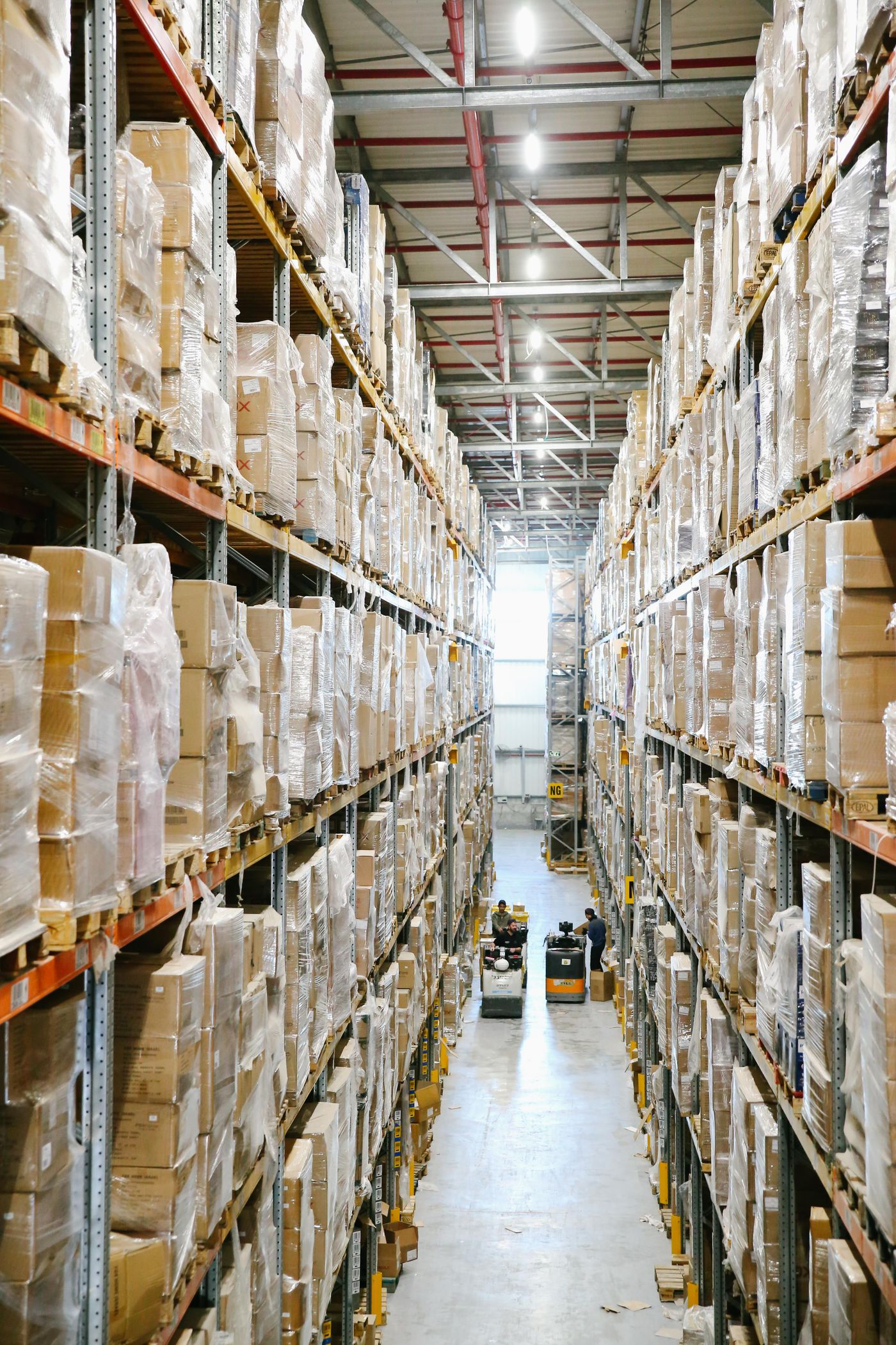 Warehouse aisle lined with shelves of boxes