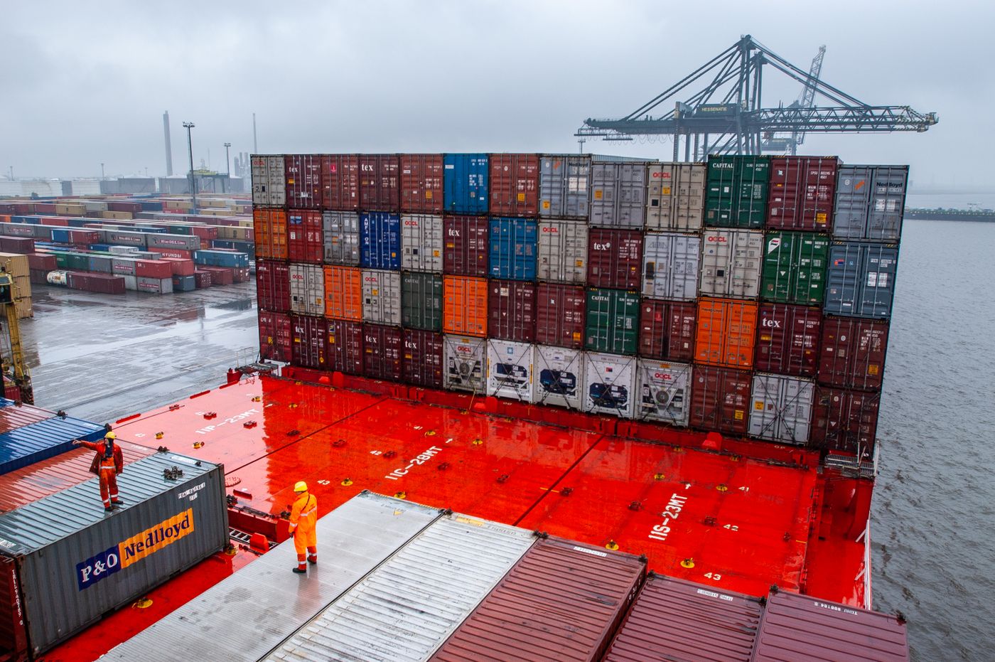 Dock workers preparing shipping containers at a terminal