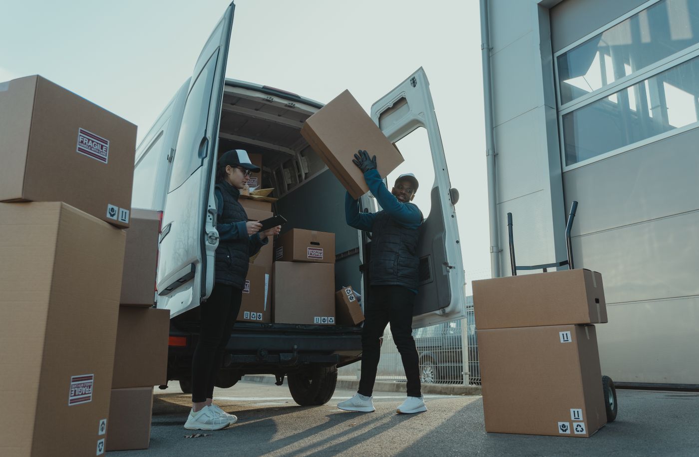 Workers loading boxes into a delivery van