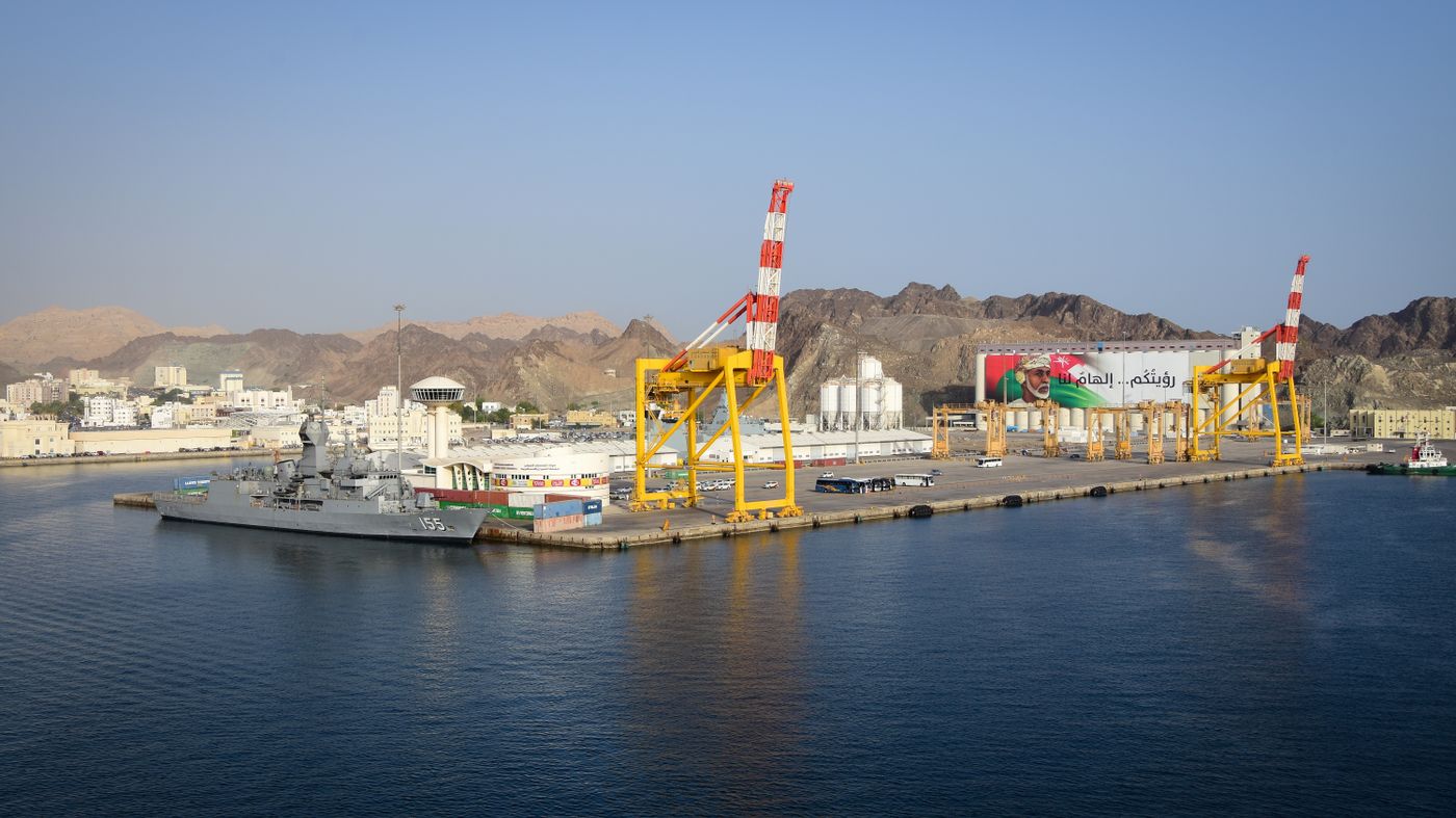 Muscat port, cranes and mountains in Oman