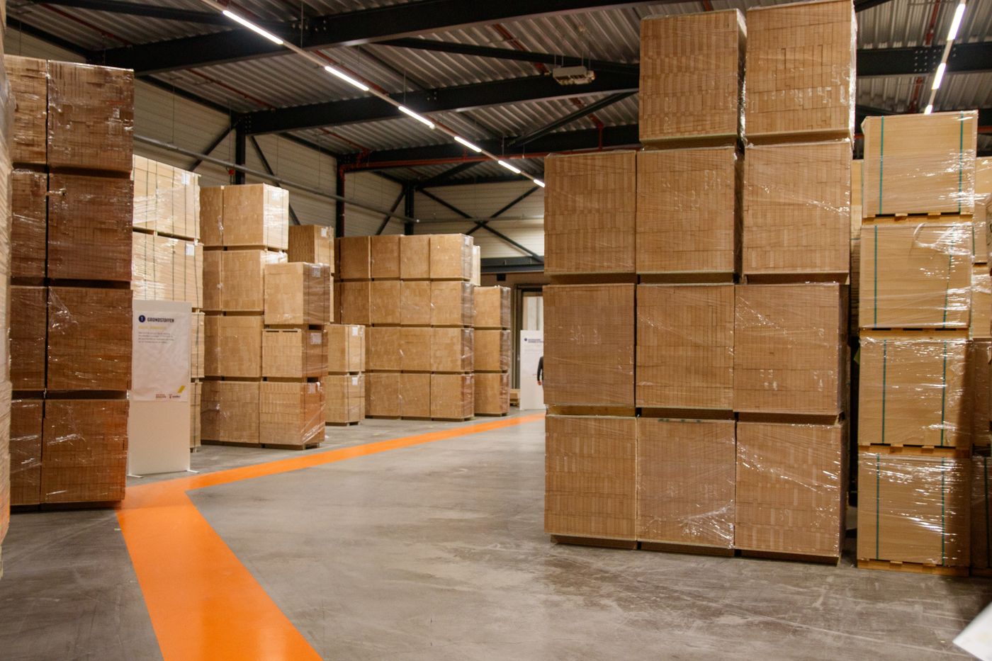 Industrial warehouse with stacked cardboard boxes